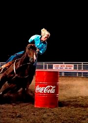 A rider competes in barrel racing 
