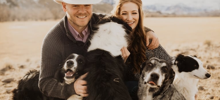 Ben & Lindsey in a field with their dogs
