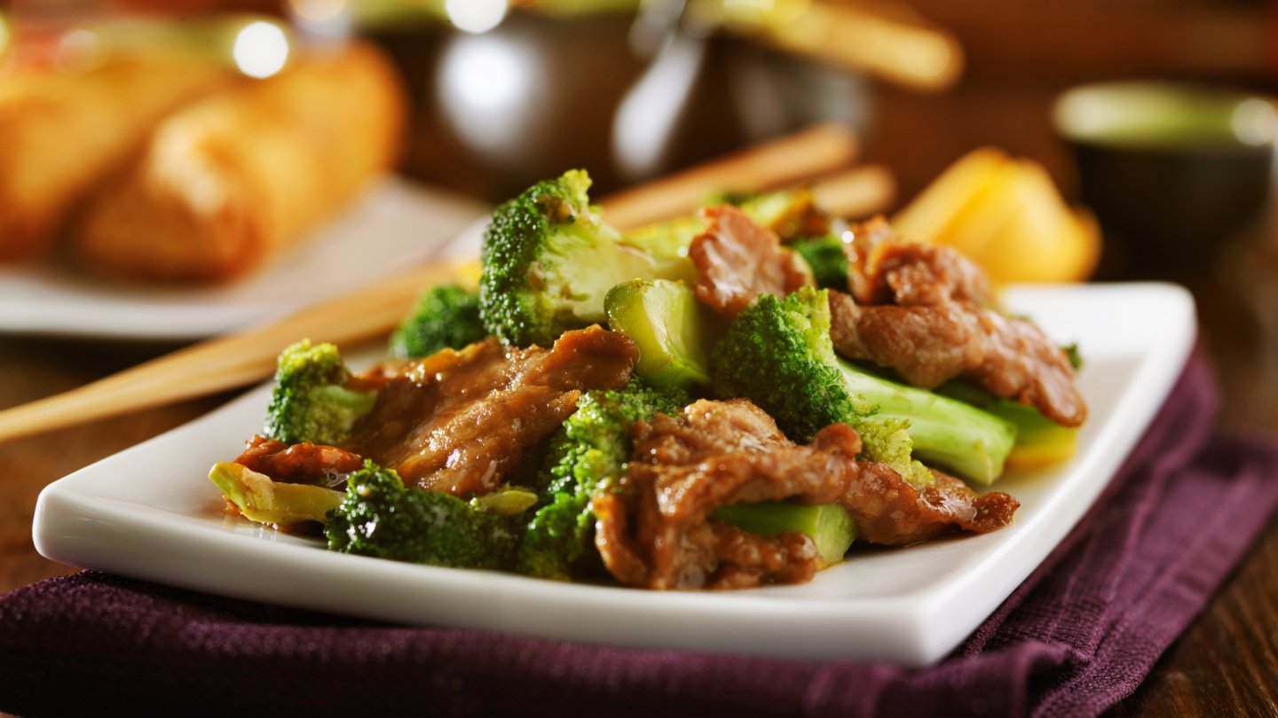 White plate full of beef and broccoli