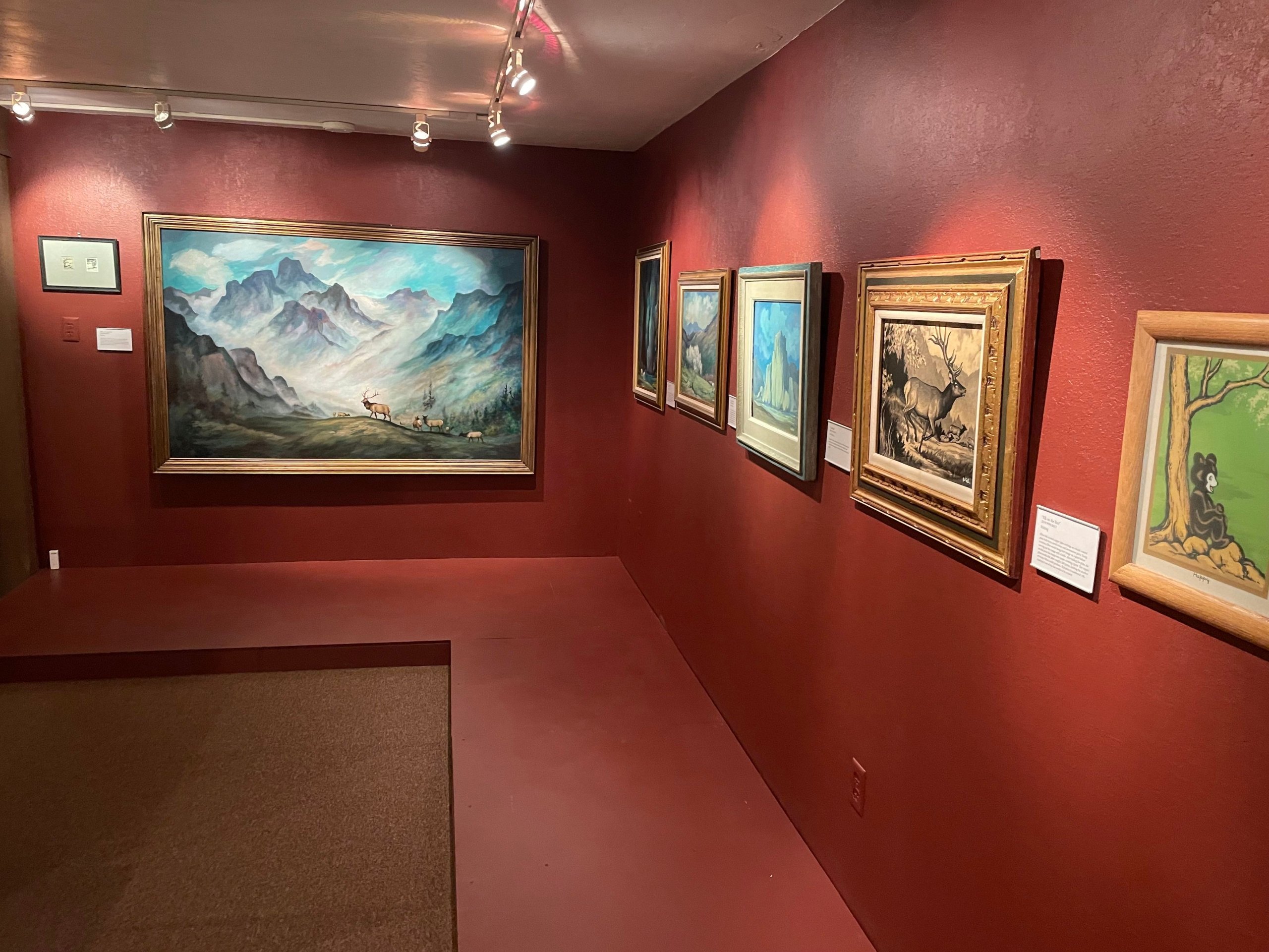 Inside a museum with paintings on the wall