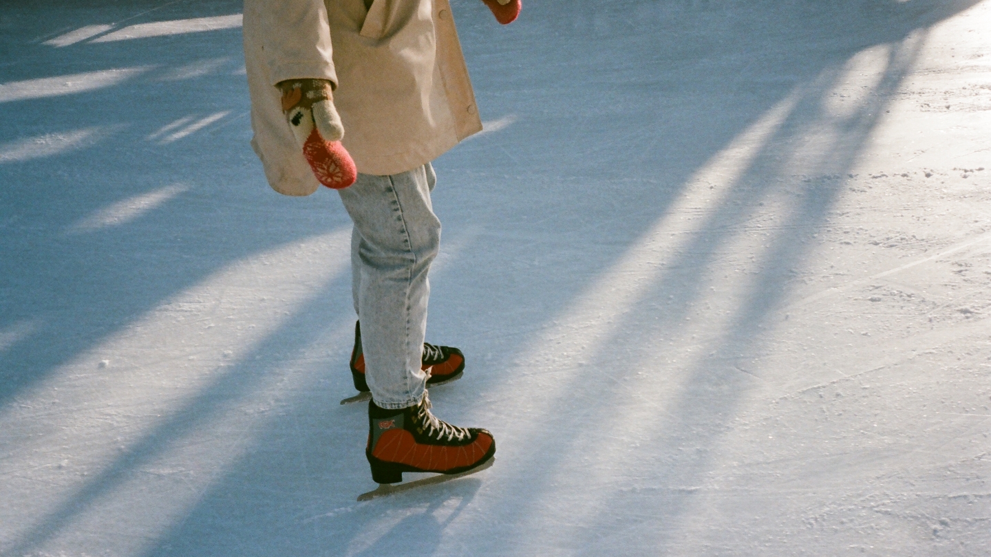 A woman skating on a lake in jeans