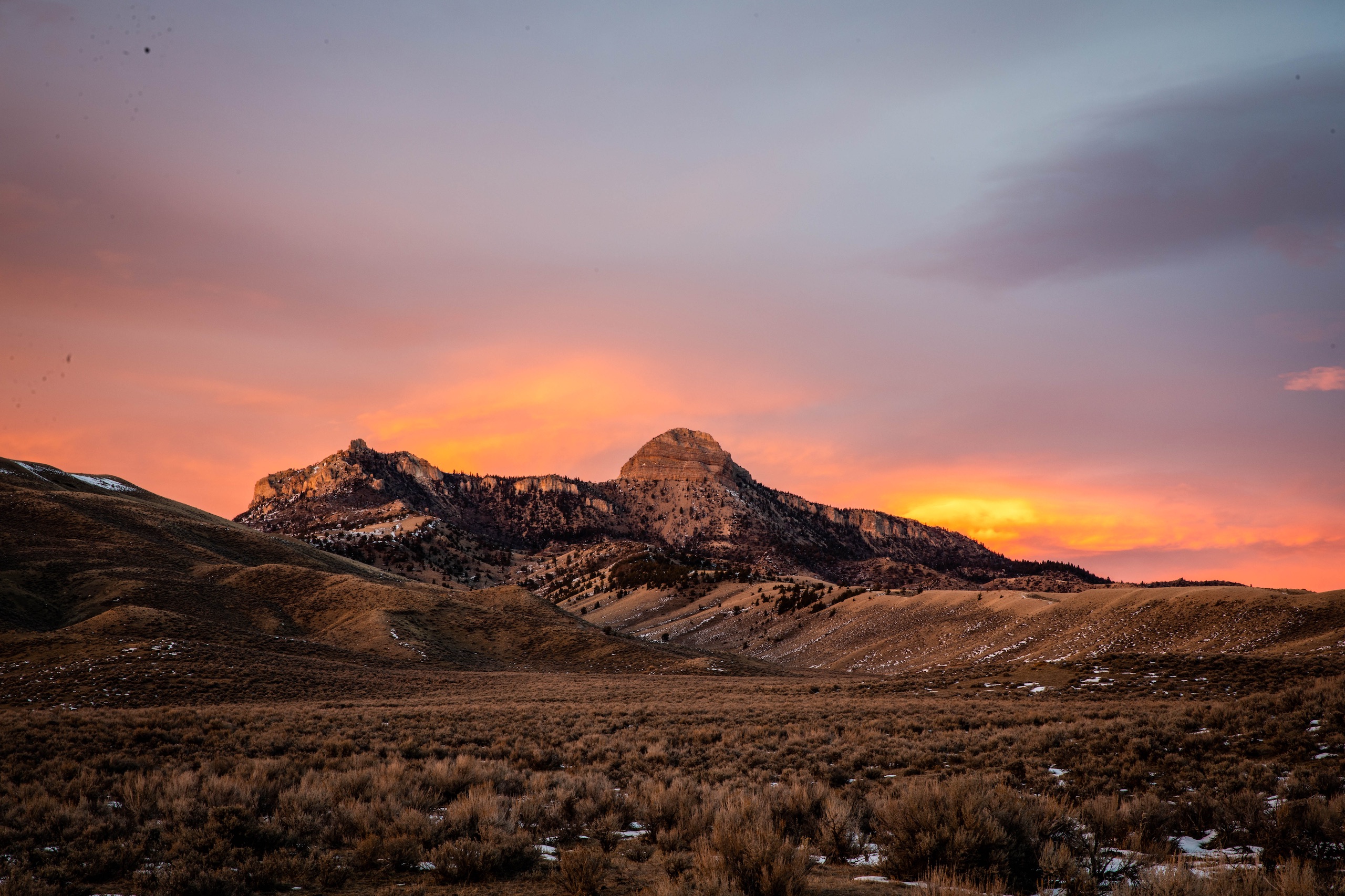 sun setting over a mountain in Yellowstone