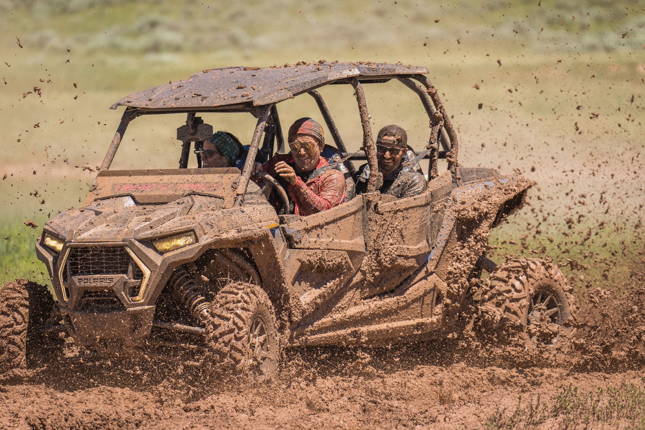 People ATV-ing through the mud