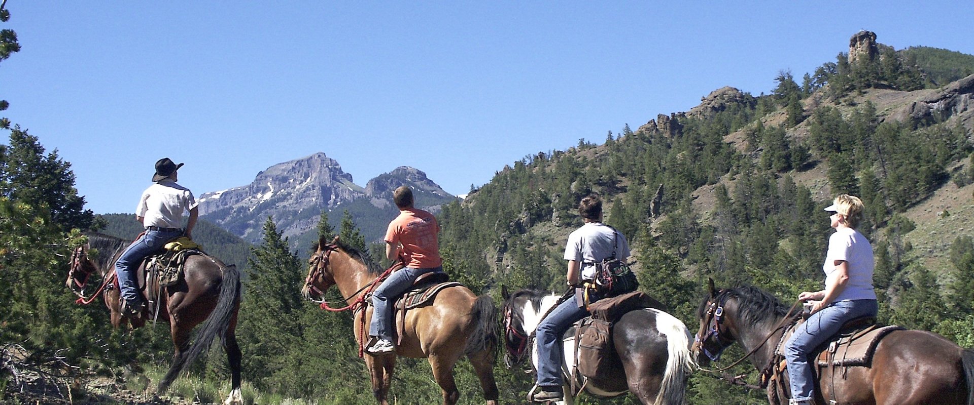 Four people horseback riding