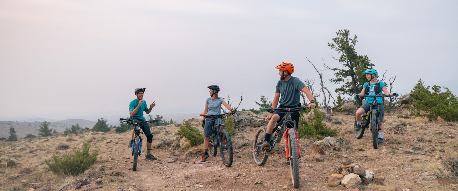 Three people biking on a cliff