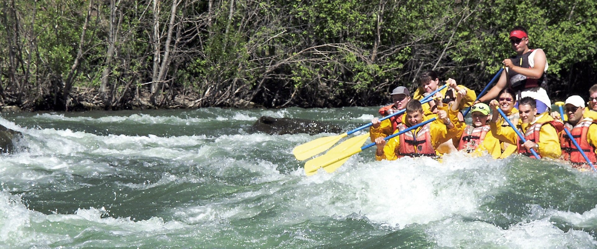 A bunch of people rafting in a large raft