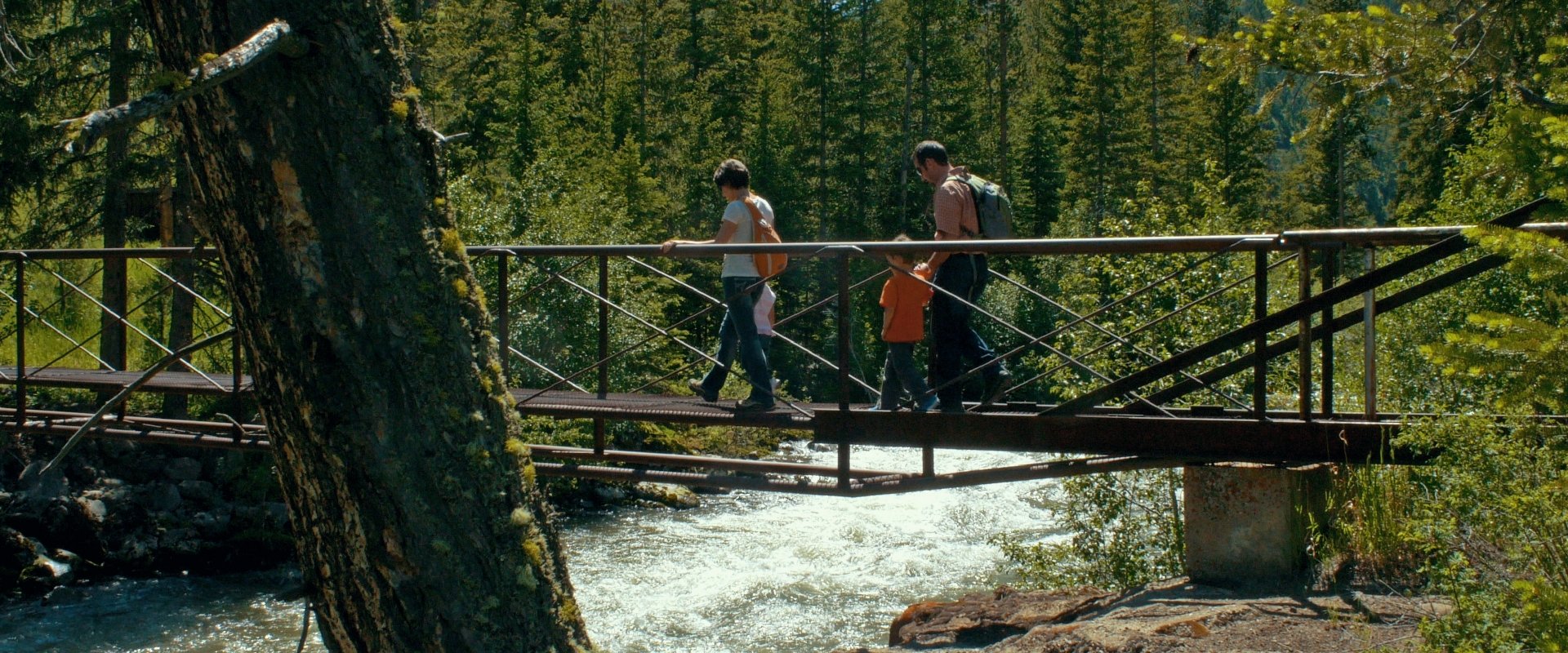 A family walking across a bridge