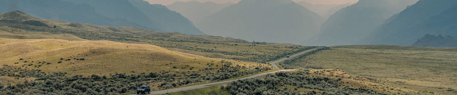 Green landscape of the mountains with a road through it