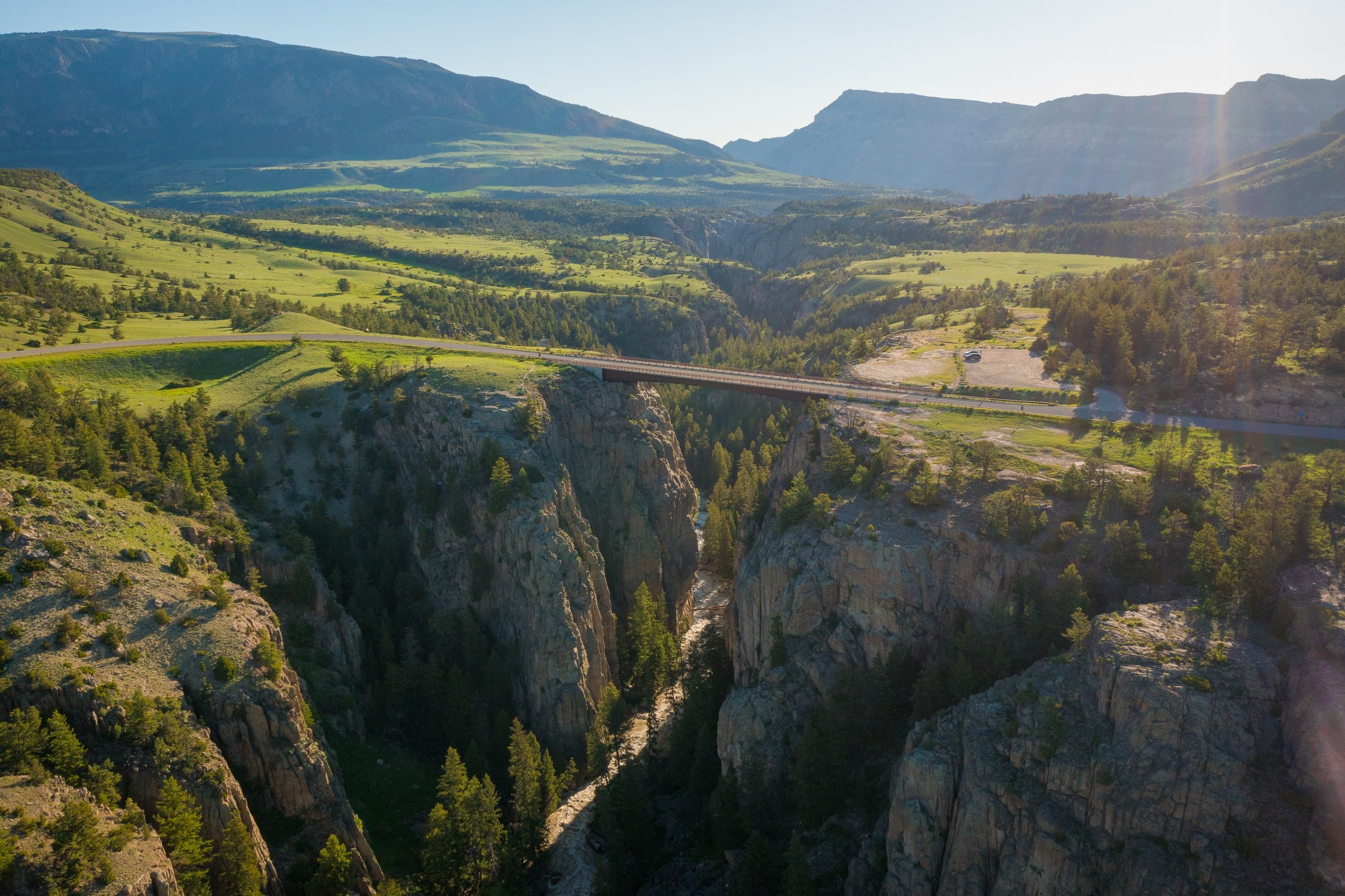 A canyon in the mountains with a bridge