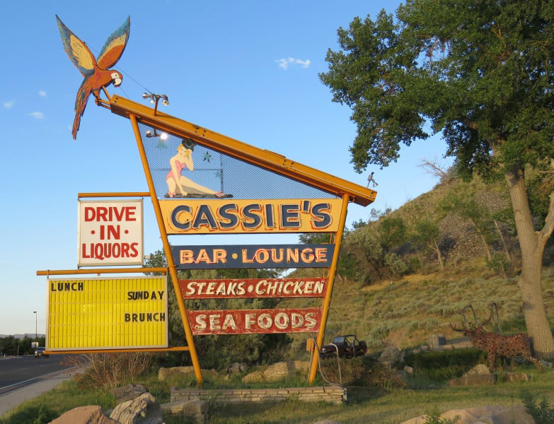 Cassie's bar sign stands tall, showcasing its lively atmosphere with bold lettering and bright colors