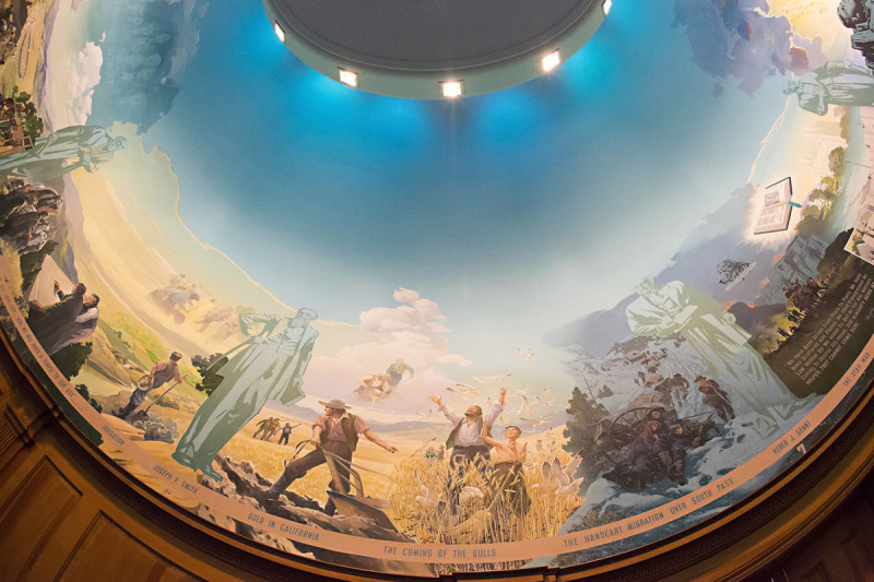 An artistic dome displaying a vibrant painting of people, creating a captivating focal point in the space below