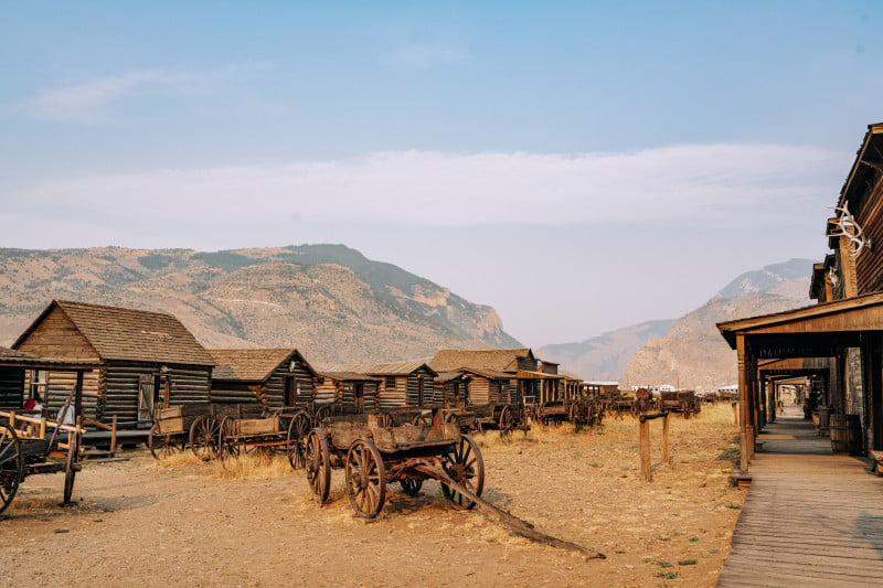 An old western town scene with classic wooden structures and horses, evoking a nostalgic Wild West atmosphere.