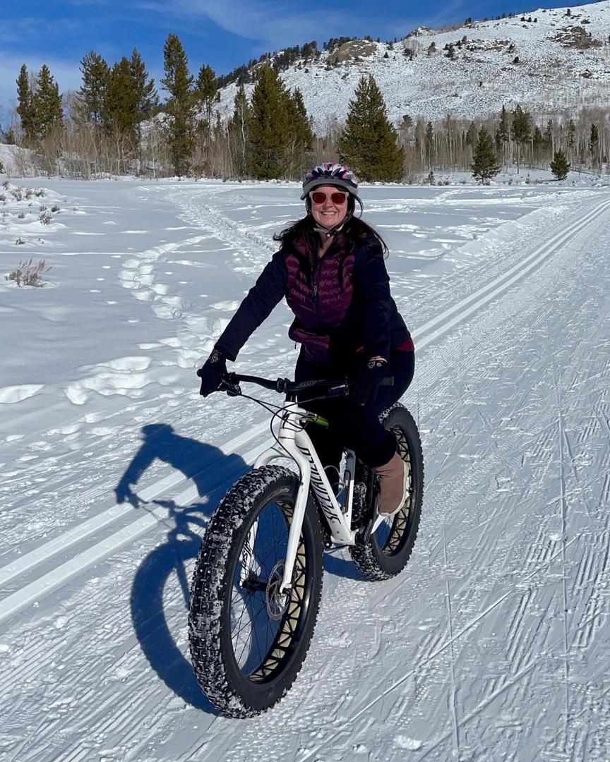 Woman riding a bike in the snow