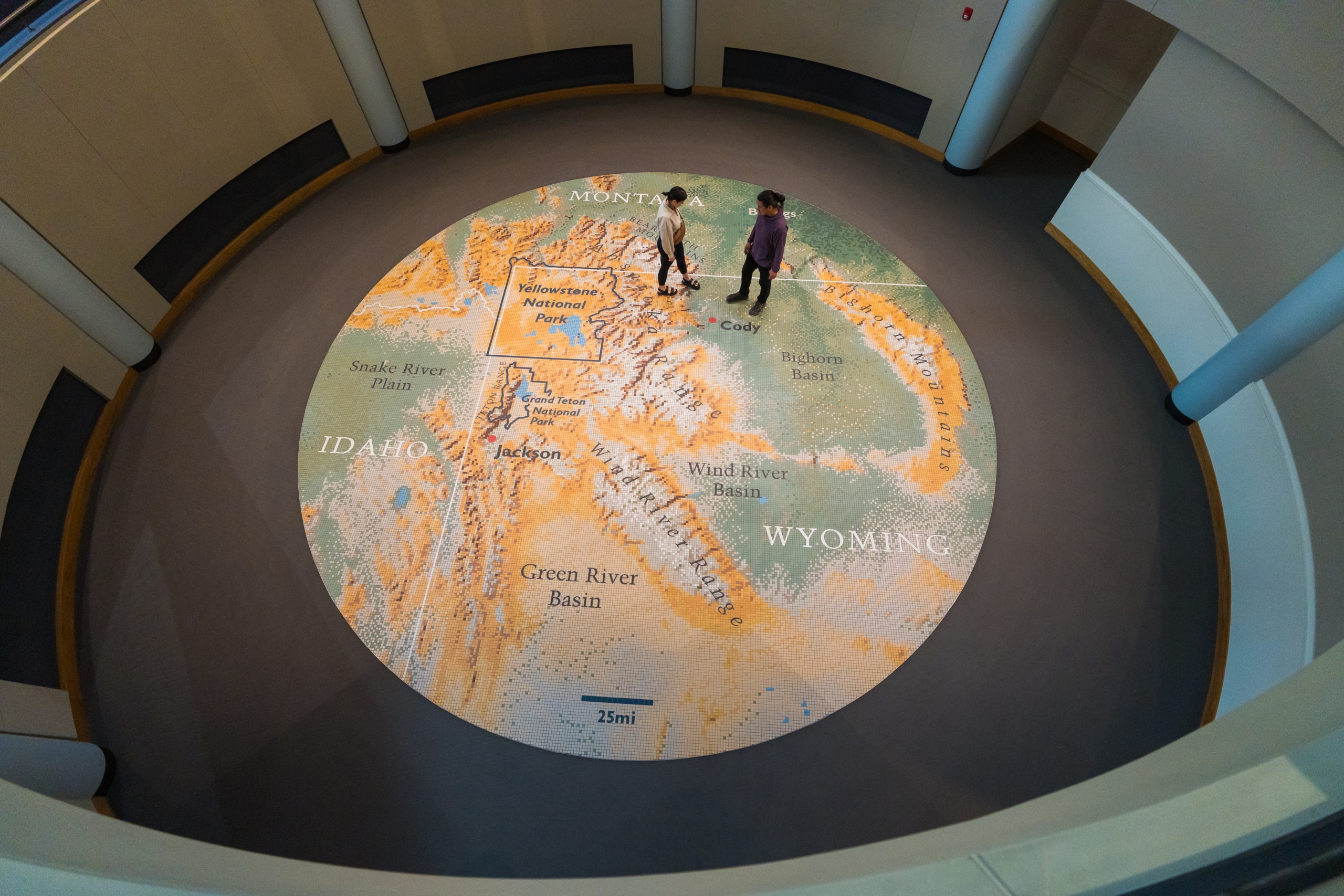 people standing on a map of Yellowstone