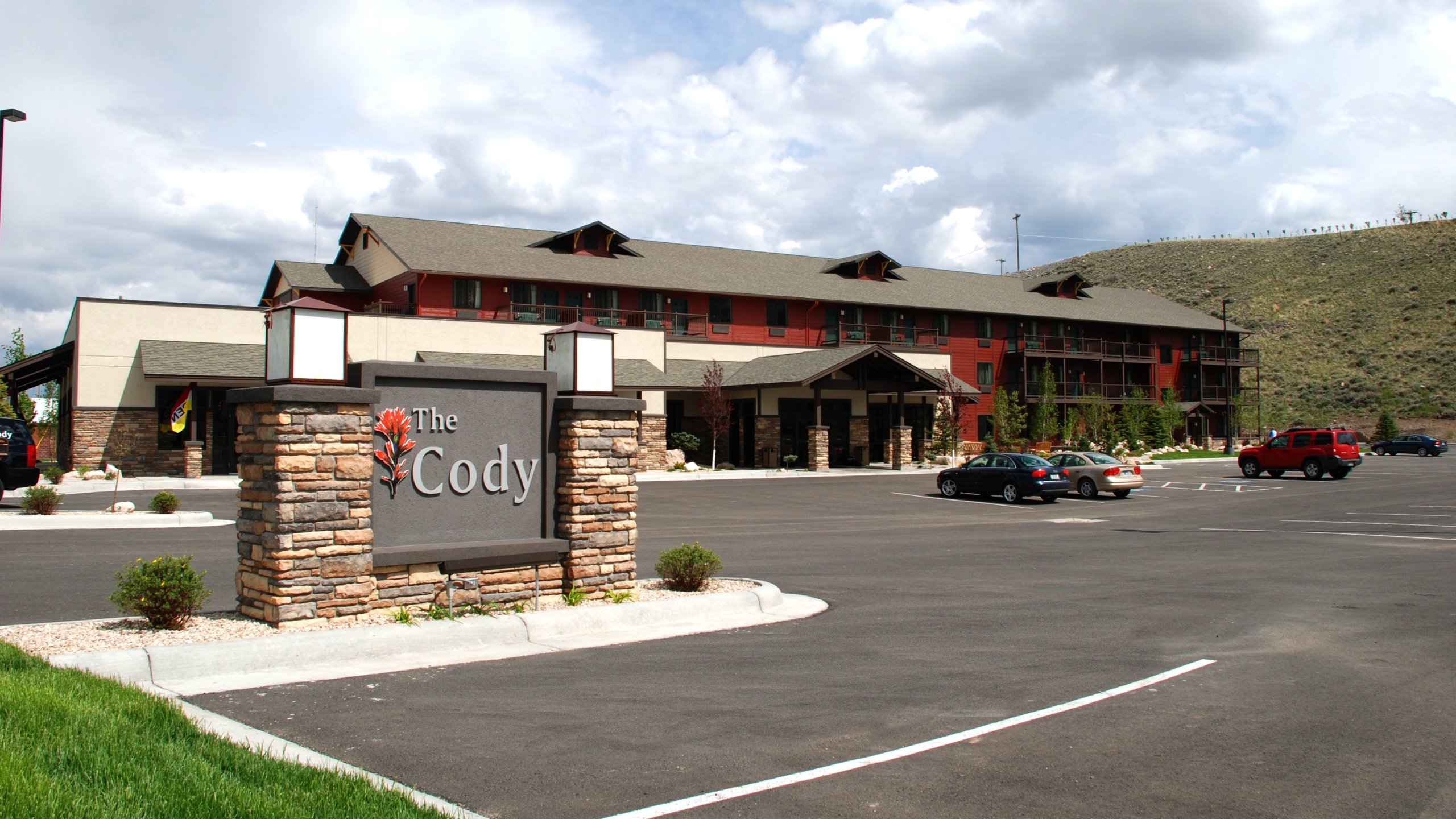 The exterior of The Cody with cars in the parking lot