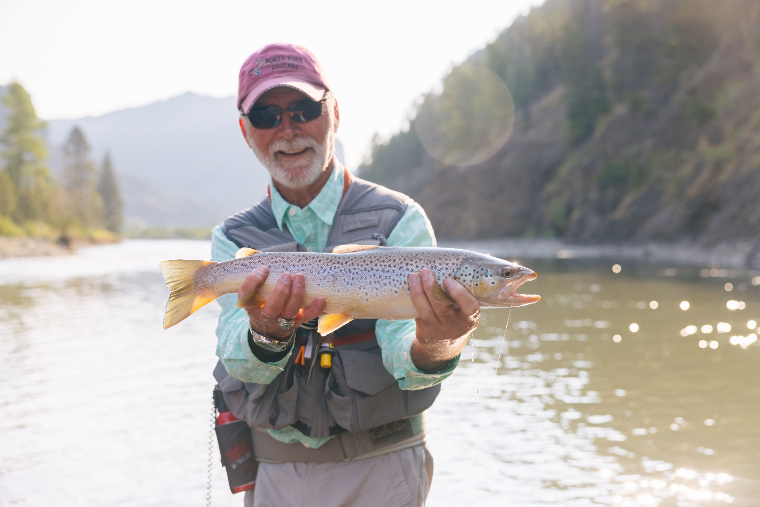 A man holding a good size trout.