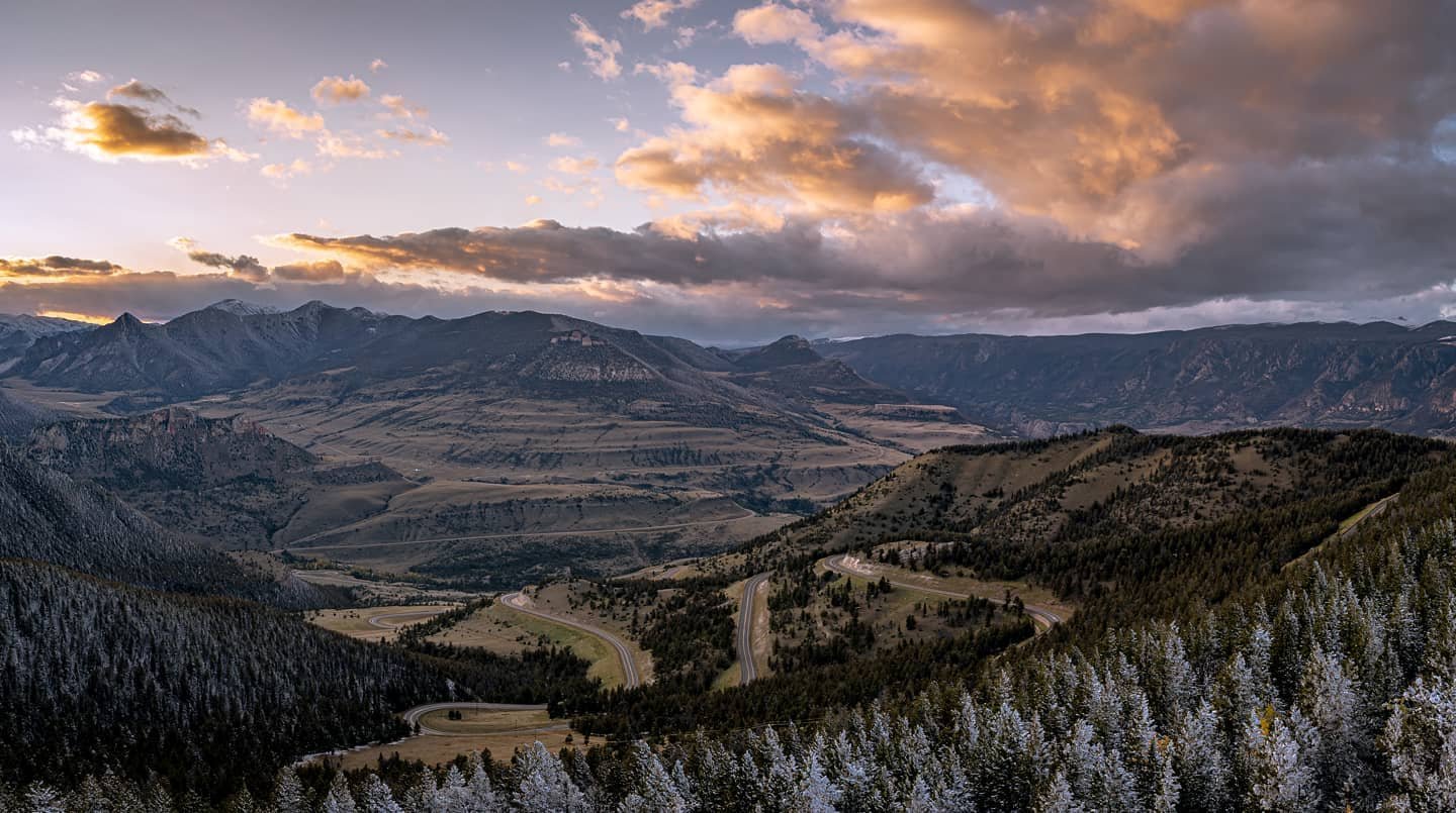 Picture taken from the top of a mountain looking into a valley and over the clouds