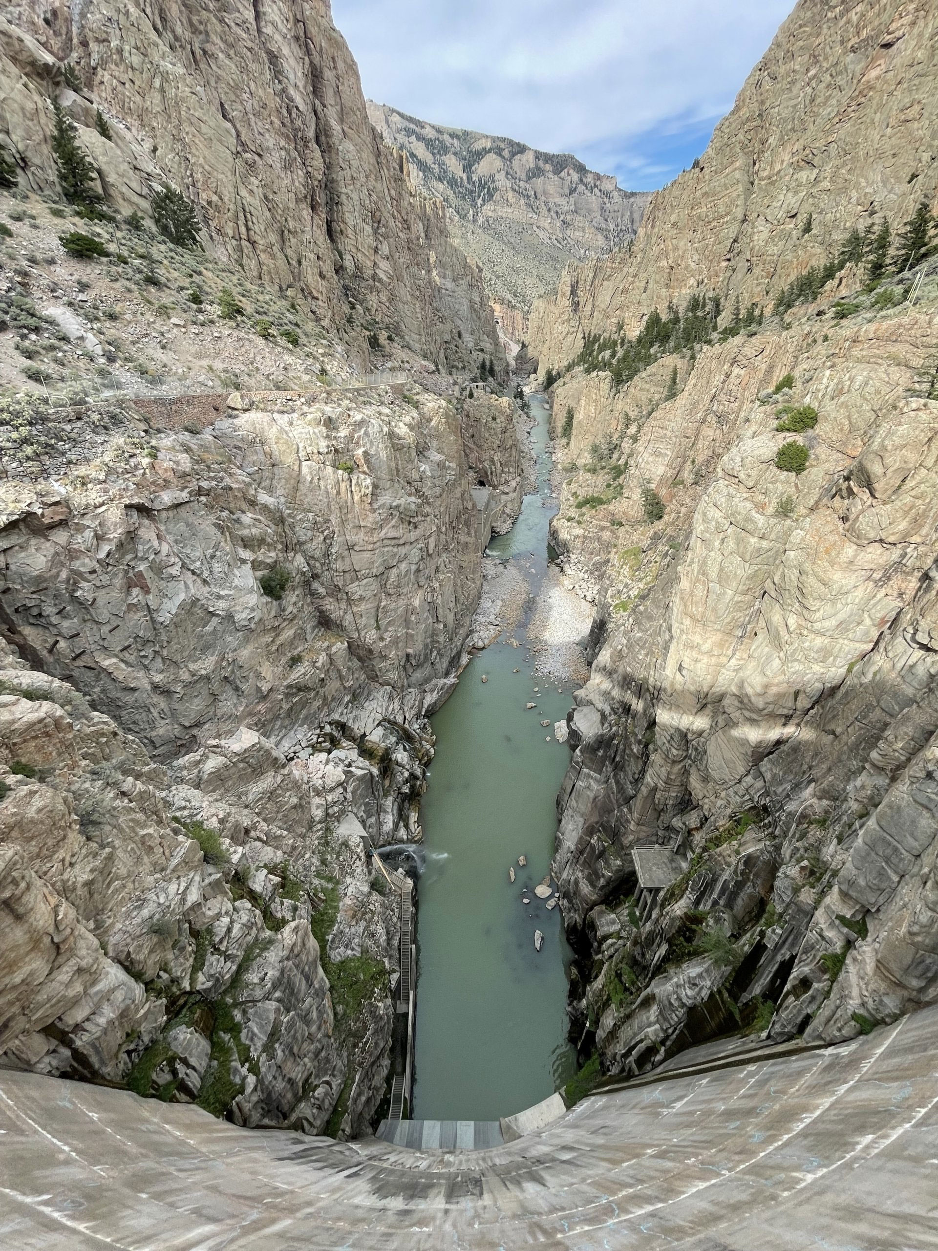 A breathtaking canyon landscape featuring a river meandering through, framed by towering rock formations and lush vegetation