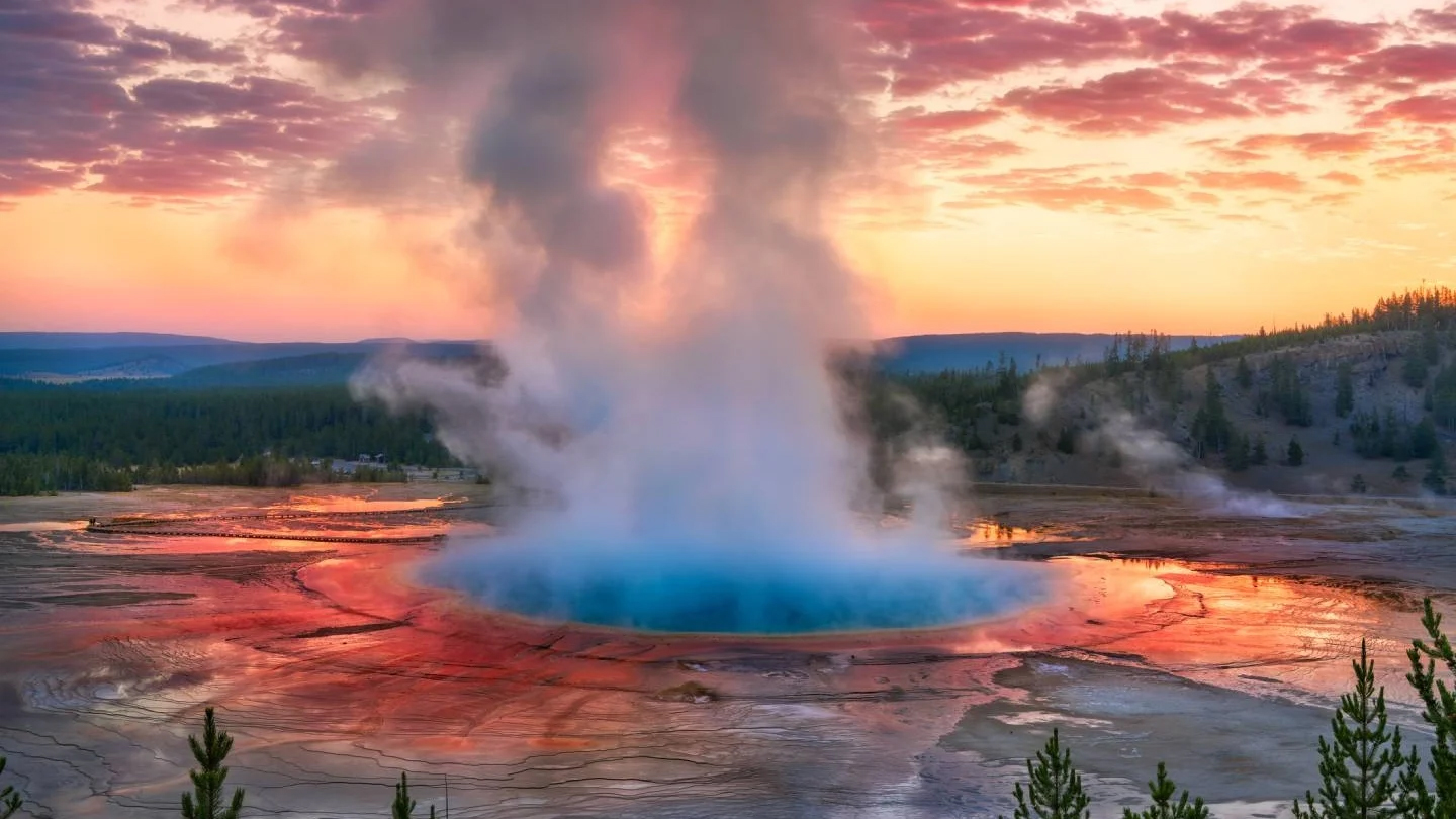 Grand prismatic spring with steam at sunset