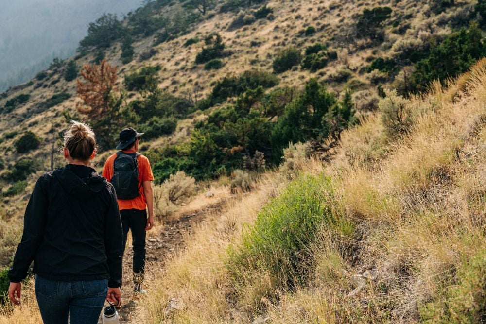 2 people hiking in the mountains of Yellowstone