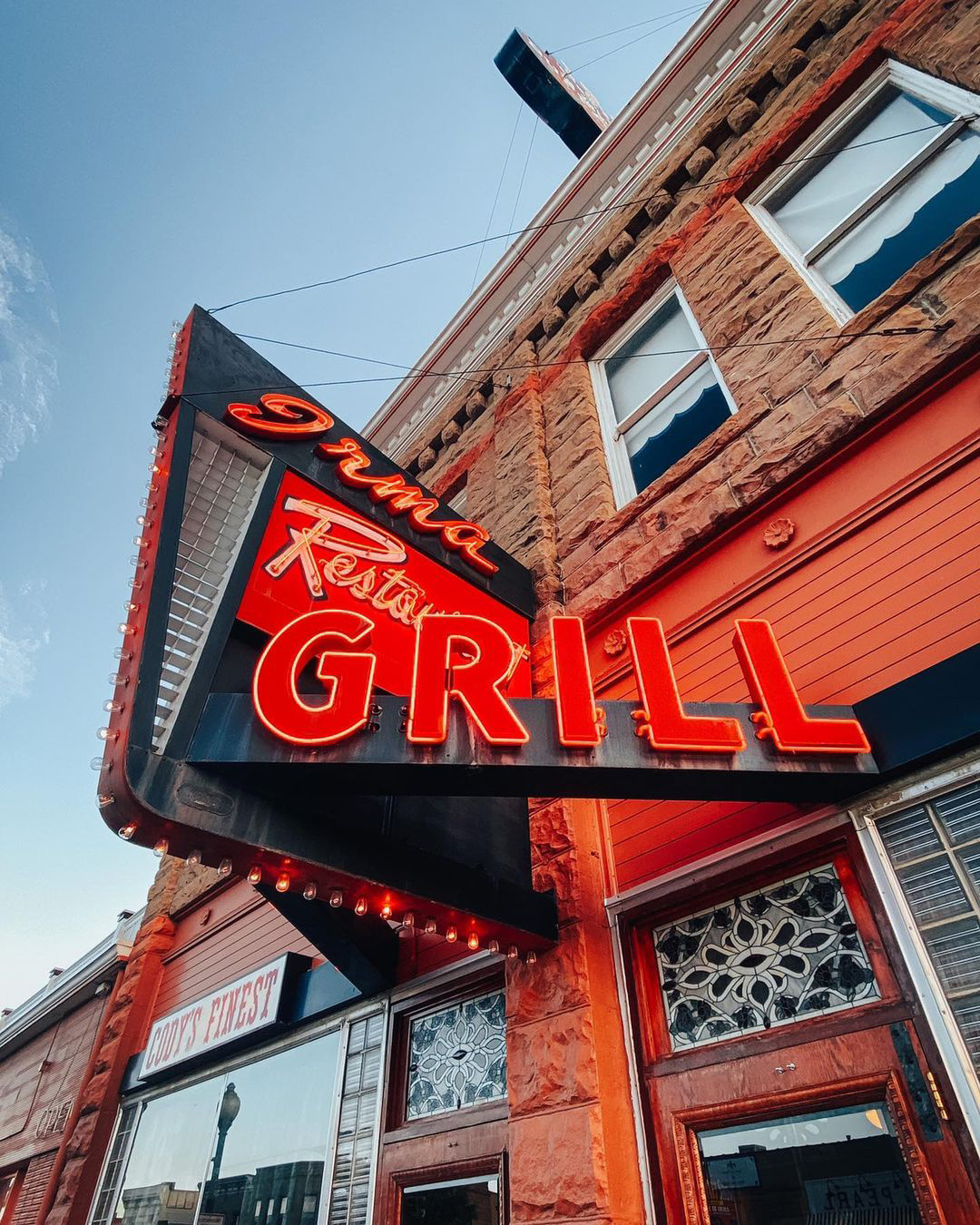 Eye-catching red neon sign at Irma Restaurant Grill