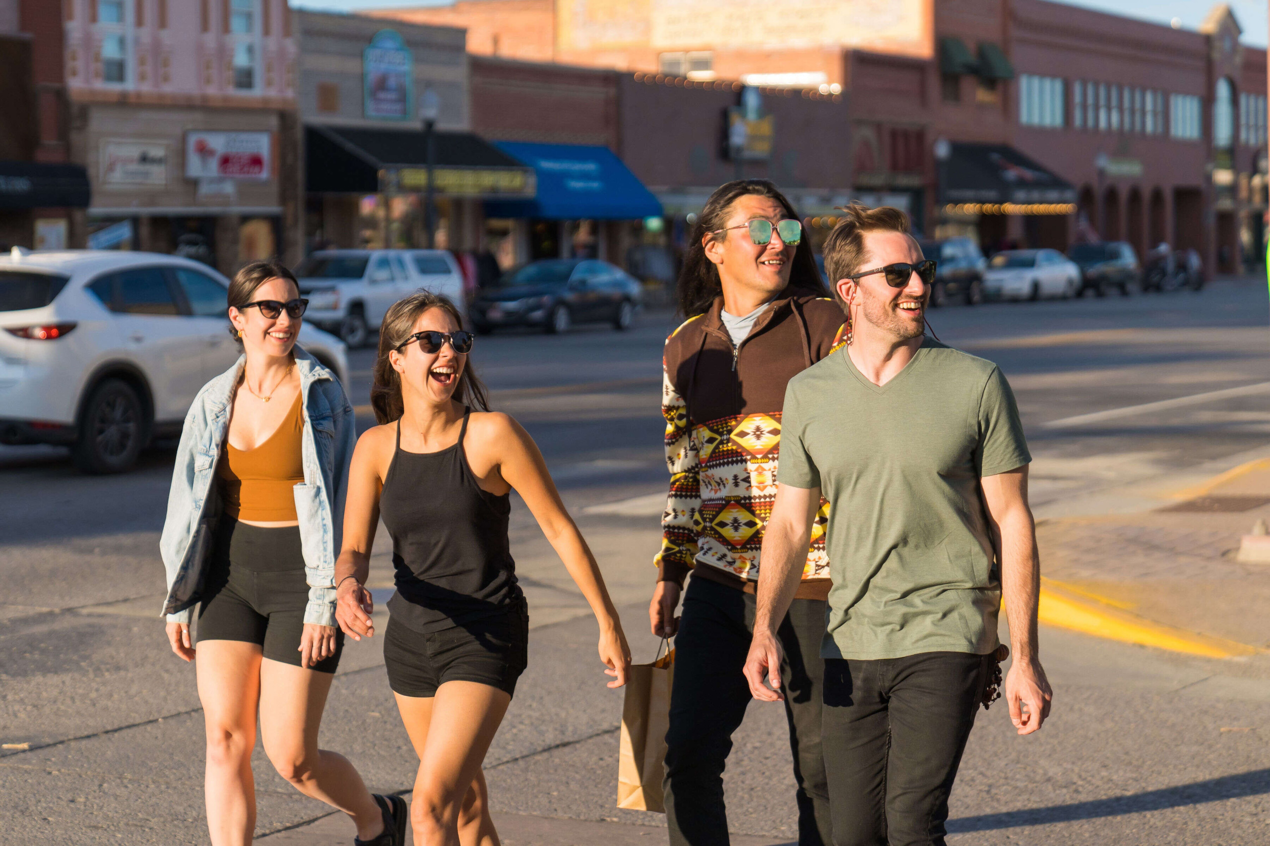 Four people walking and enjoying the tour on streets in Cody