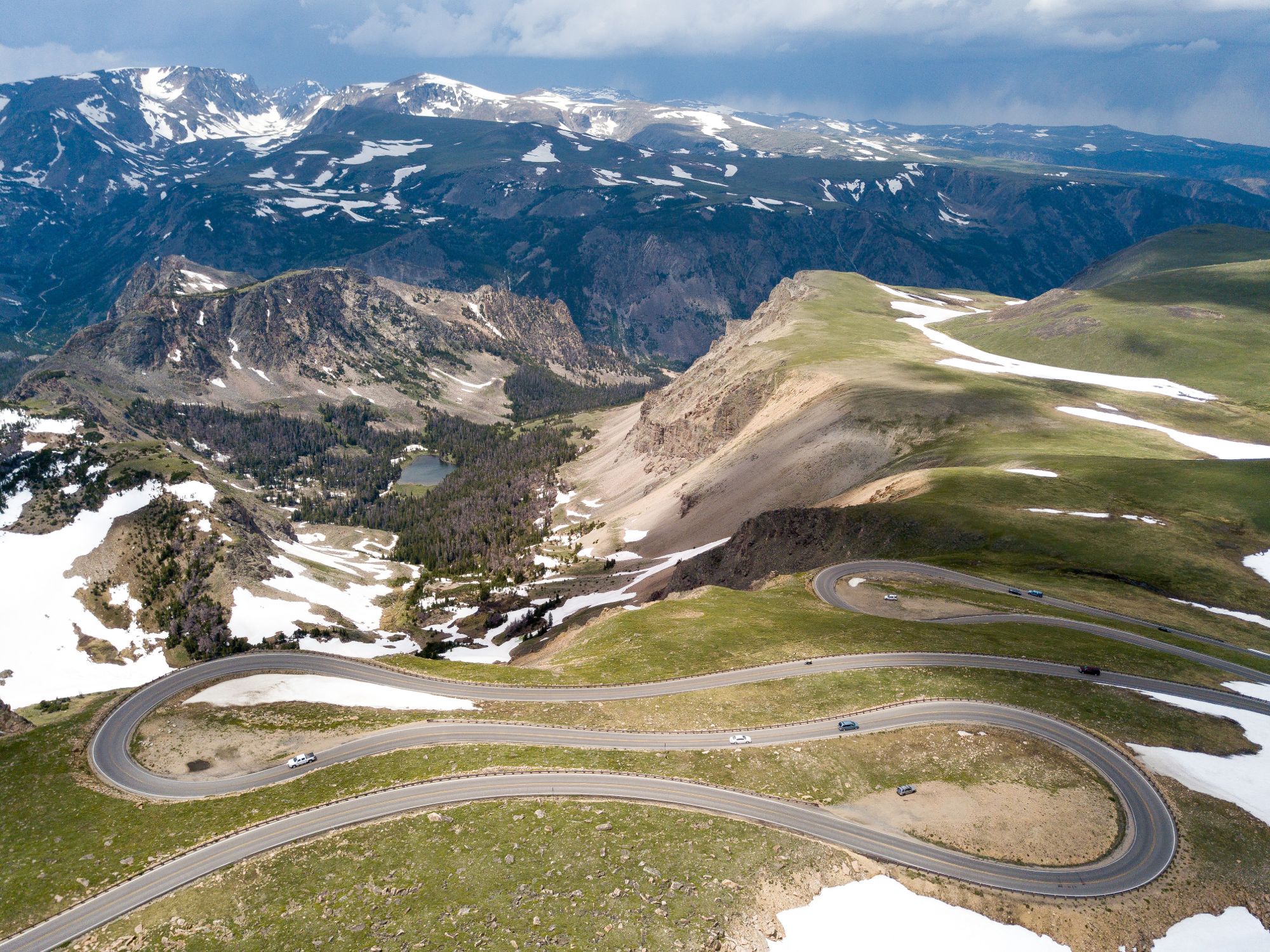 A picturesque view of a mountain range with a road meandering through, showcasing nature's beauty and inviting exploration