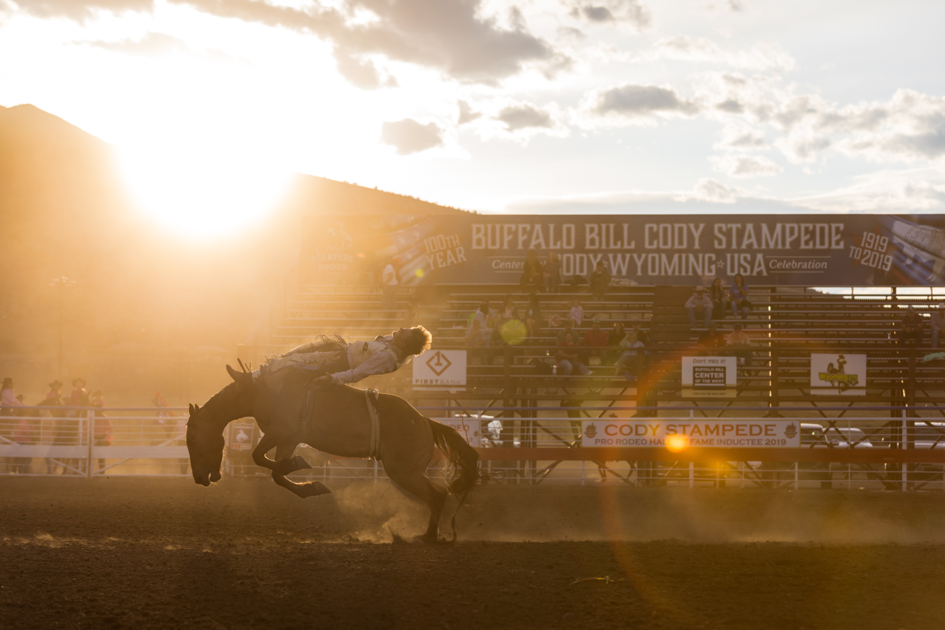 Man riding wild horse at a rodeo.