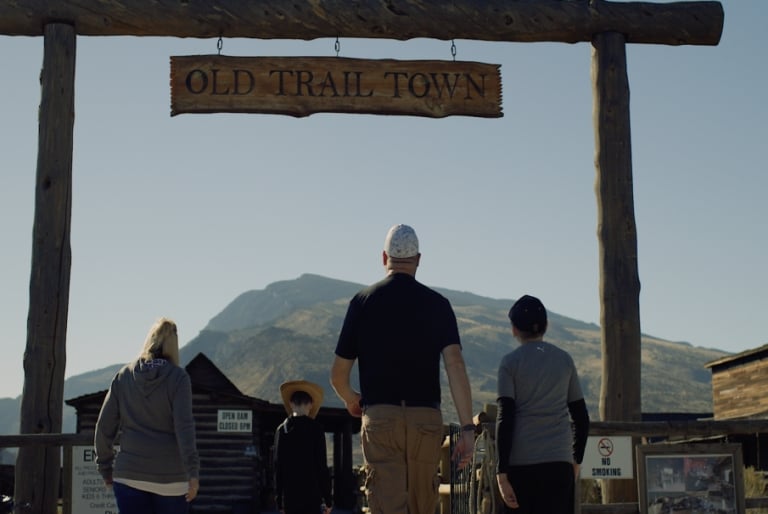 A family entering Old Trail Town.