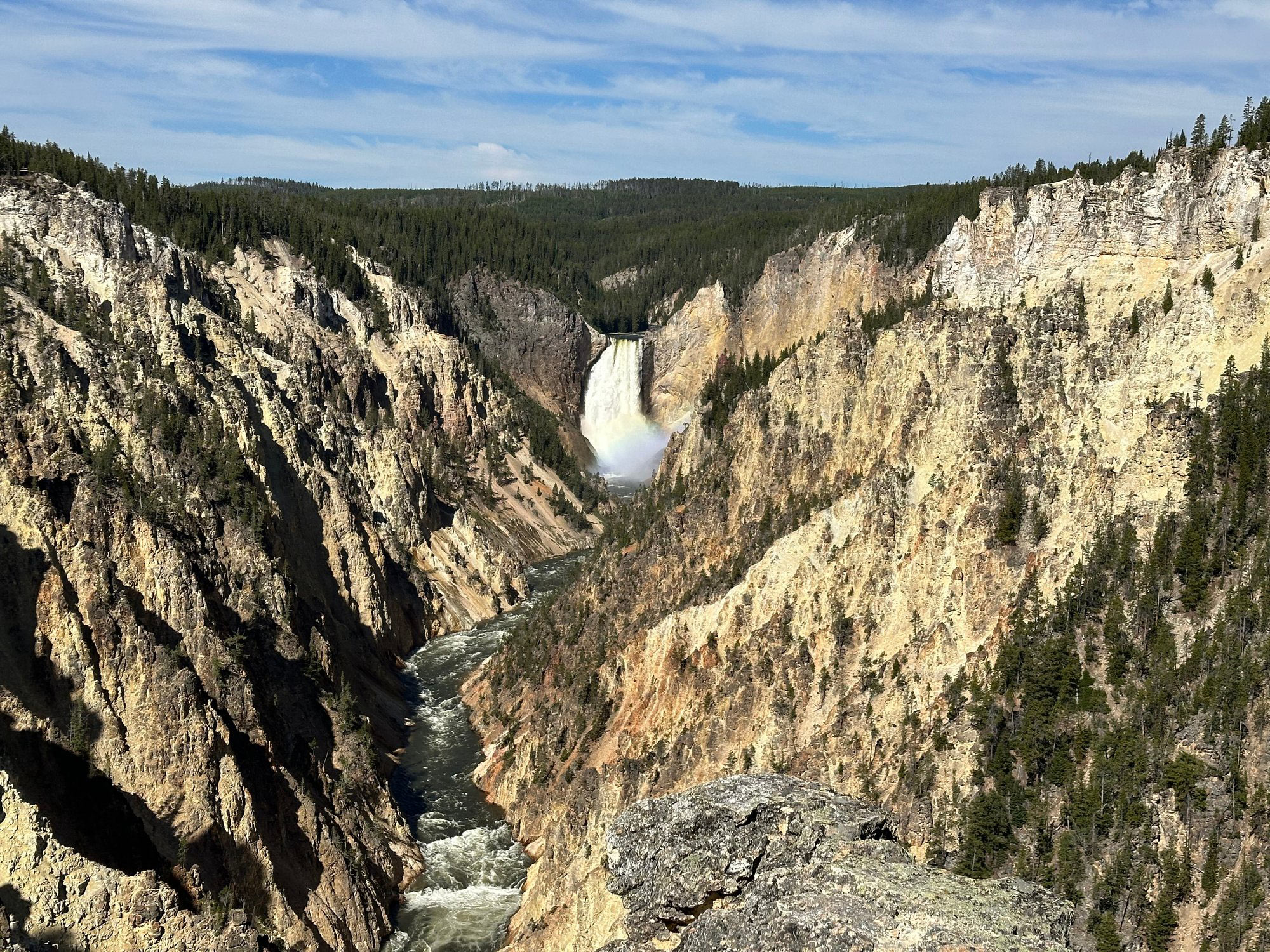 Stunning landscape of the Grand Canyon of Yellowstone, featuring colorful cliffs and the serene Yellowstone River flowing through