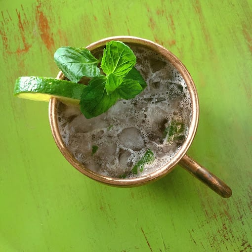 Top view of a cocktail with mint and a lime