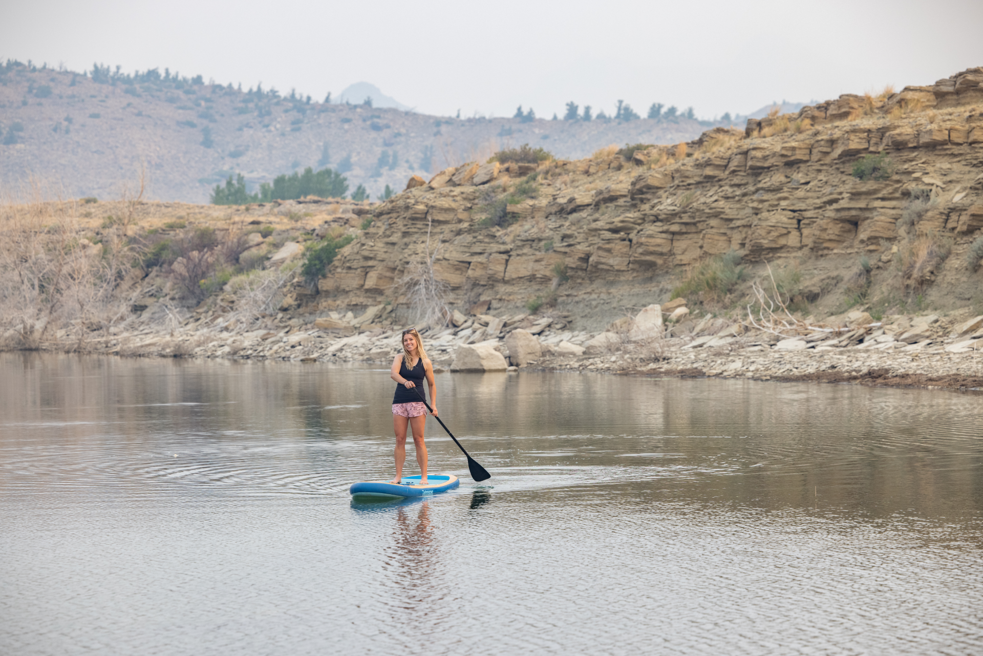 A woman paddle boarding