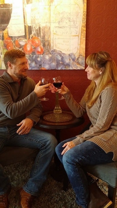 A man and a woman having a glass of wine in a bar.