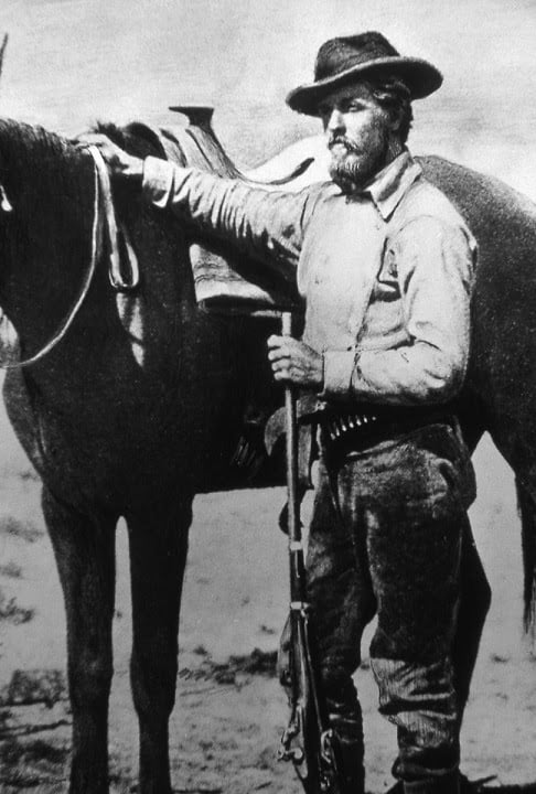 Willian Henry Jackson standing beside a horse