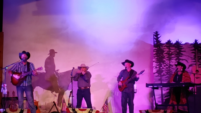 4 people performing on stage at The Cody Cattle Company