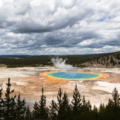 An open area of land with a hot spring in the middle.