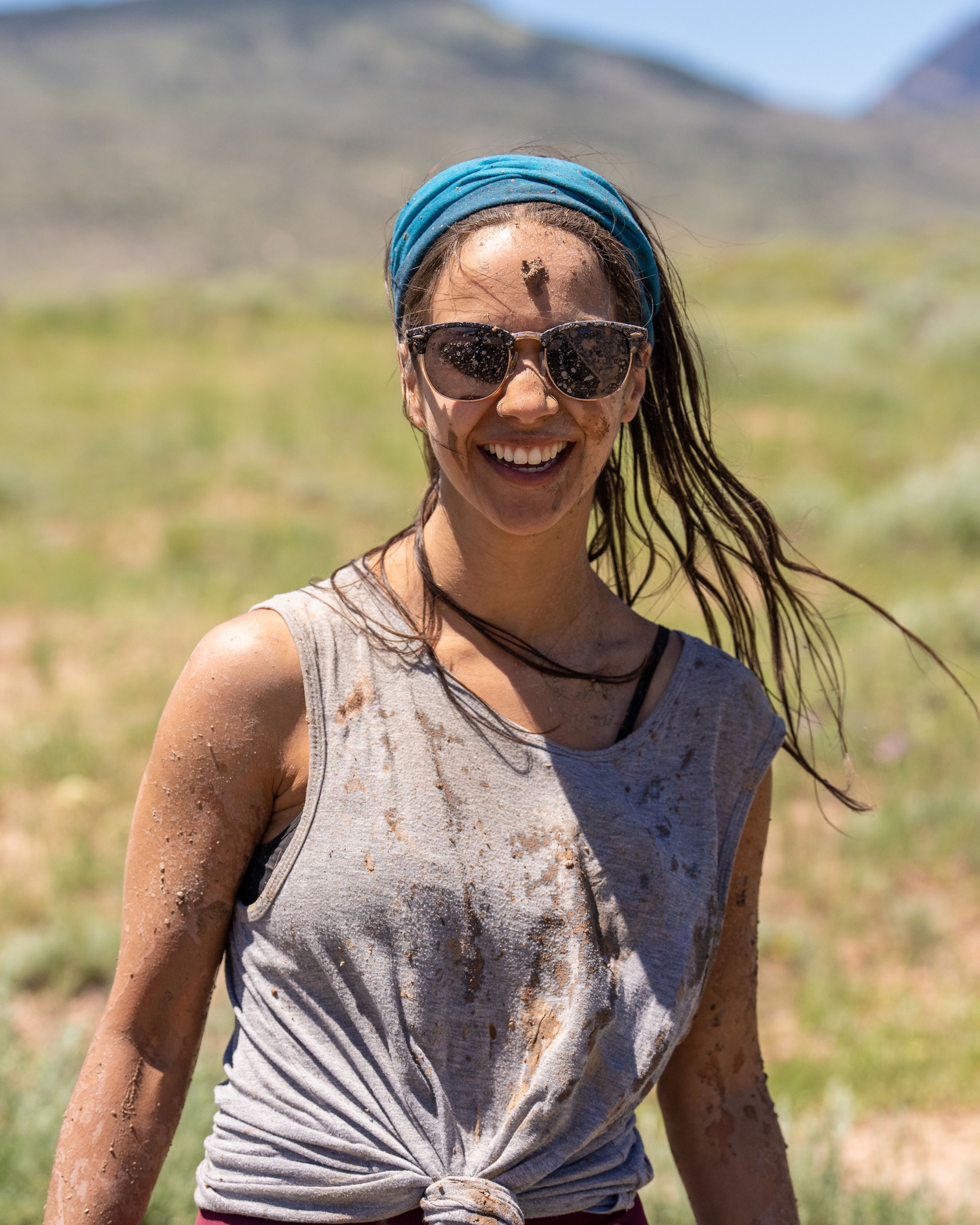 A woman with mud all over her.