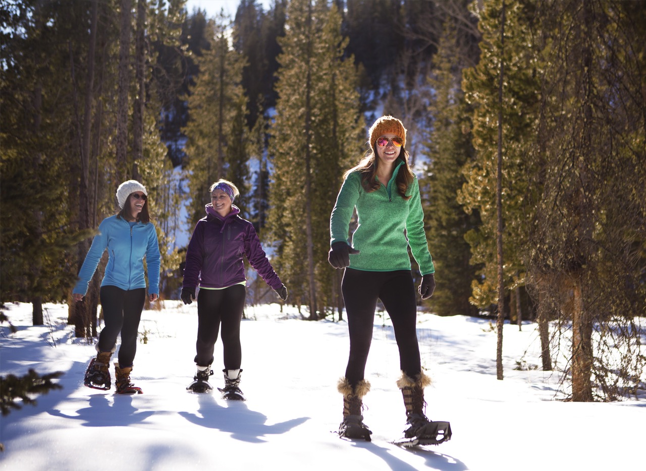 3 women snowshoeing in Cody Yellowstone