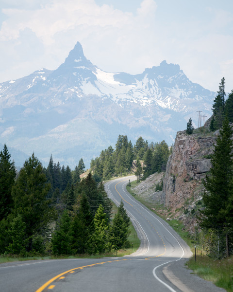 A road in the mountains with a gorgeous mountain in the foreground.