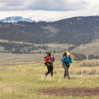 Two women hiking together in Yellowstone together.