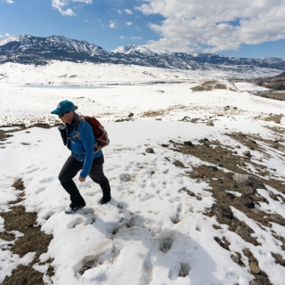 Women hiking in the snow in Yellowstone alone.